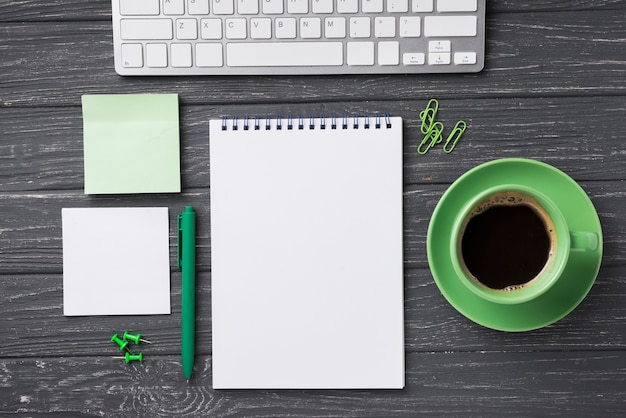 Top view of organized desk with coffee cup and sticky notes