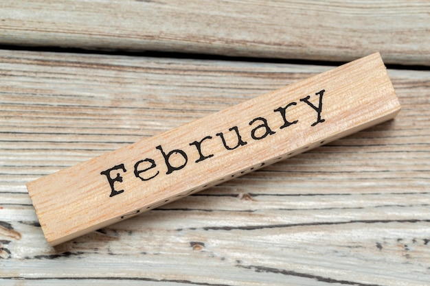 top view of parts of wooden calendar on dark wooden tabletop