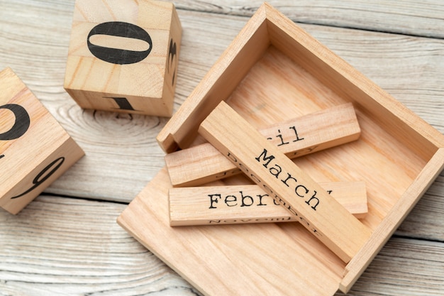 top view of parts of wooden calendar on dark wooden tabletop