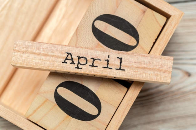 Top view of parts of wooden calendar on dark wooden tabletop