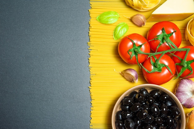 Top view: pasta or italian spaghetti on black stone slate background