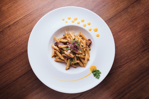 Top view of Penne with crispy fish and sweeten pork in Thai spicy chili sauce 