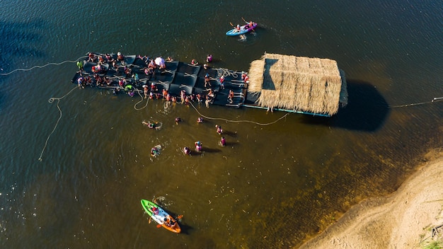 Top view People play water near a wooden raft floating on river chanaburi Thailand