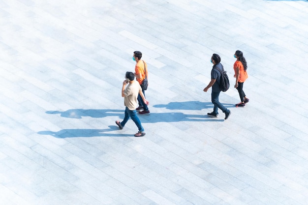 Top view people with face mask walk on pedestrian Human life in Social distance Aerial urban