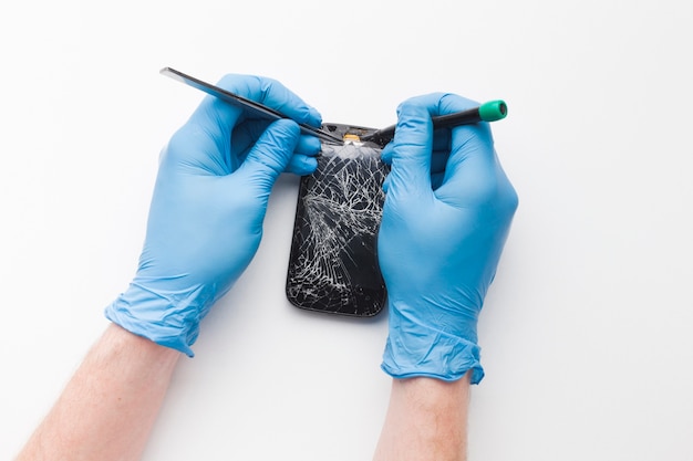 Top view person repairing a smartphone