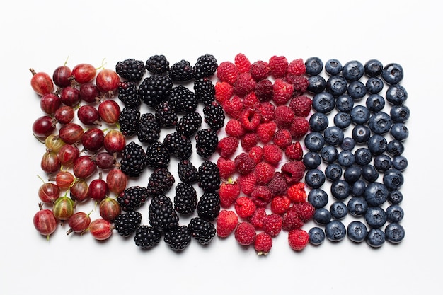 Top view photo of blueberries, raspberries, blackberries and gooseberries.