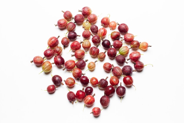 Top view photo of fresh gooseberries spread on the white background.