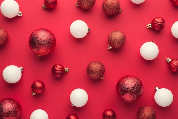 Top view photo of red and white christmas tree balls on isolated red background