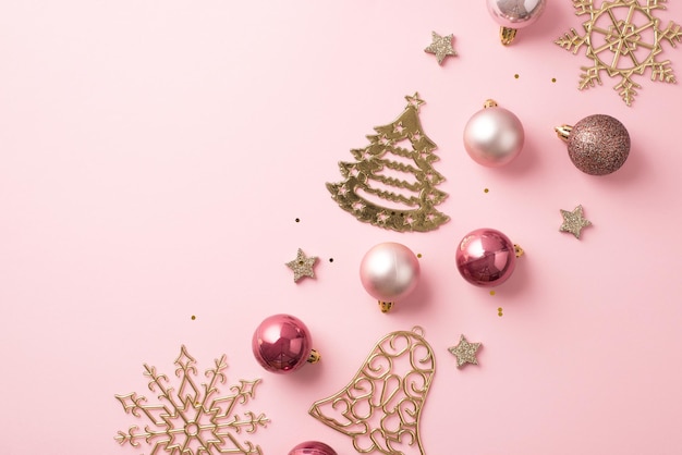 Top view photo of row composition christmas tree decorations pink balls gold bell pine snowflake shaped ornaments glowing stars and sequins on isolated pastel pink background with copyspace