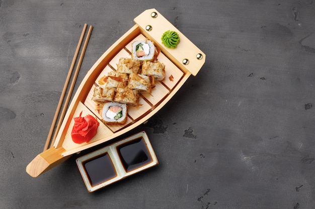 Top view photo of sushi roll with tuna shavings served on plate