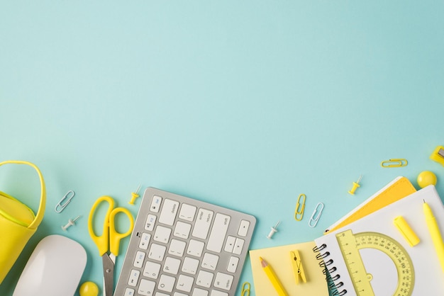 Top view photo of yellow stationery pen pencil ruler sharpener pencilcase scissors pins clips sticker notepad keyboard and mouse on isolated pastel blue background with copyspace