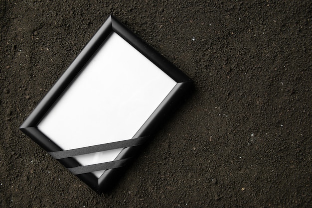 Top view of picture frame on a dark soil