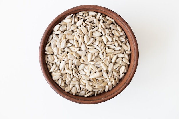 Top view of a pile of natural organic sunflower seeds isolated on white background