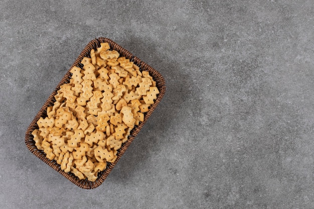 Top view of pile of small biscuits in basket 