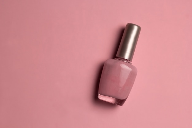 Top view pink nail polish on pink background