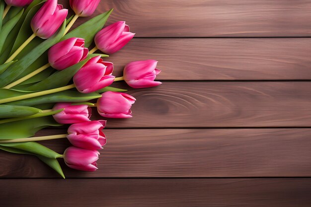 Top view of pink tulips on wooden table