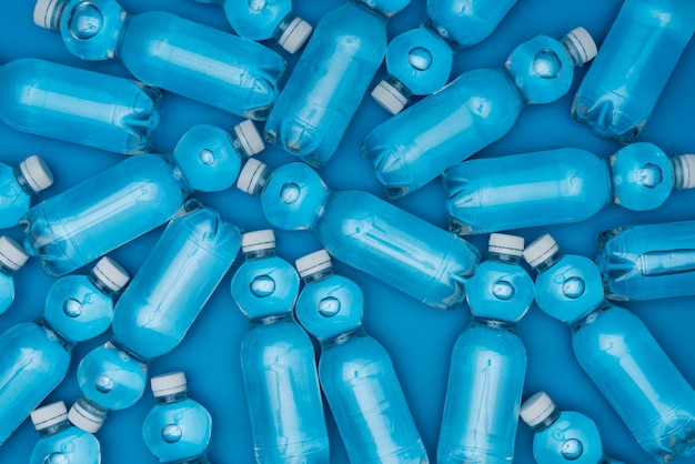 Top view of plastic water bottles isolated on blue