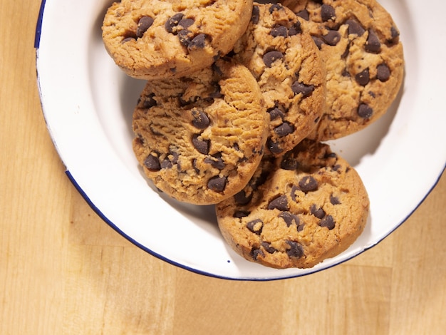 Top view of a plate of homemade chocolate chip cookies on a wooden table