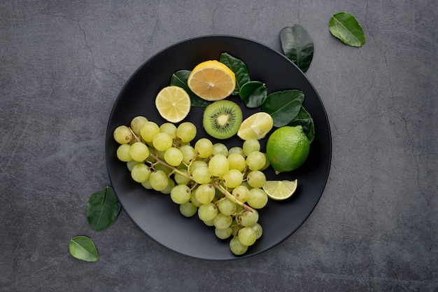 Top view of plate with grapes and kiwi