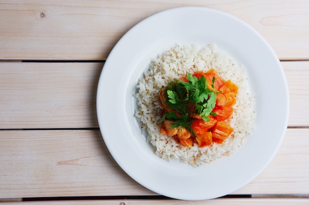 Top view of plate with rice, chicken fillet and bell pepper