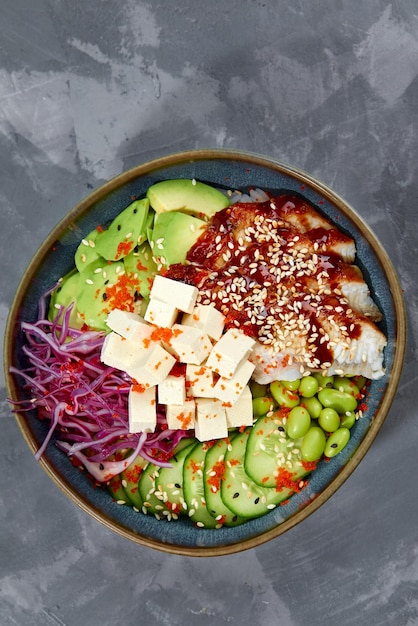 Top view on poke salad with eel and green vegetable in the bowls on gray background Copy space