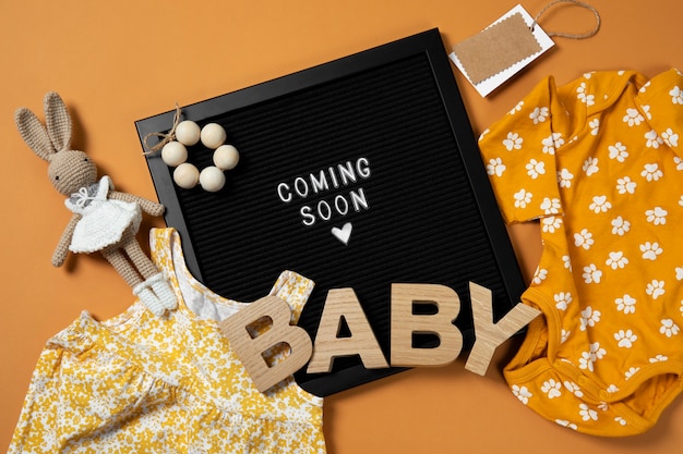 Top view pregnancy announcement with baby items