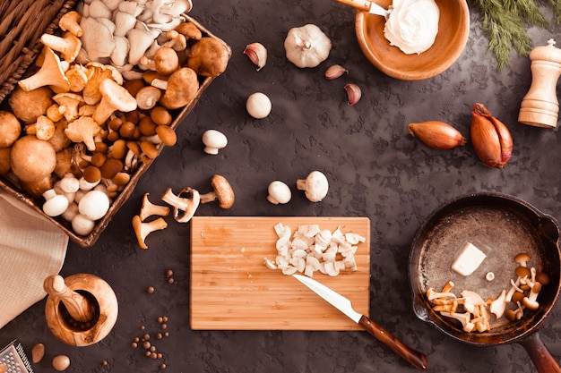 Top view of preparation and frying of edible wild mushrooms