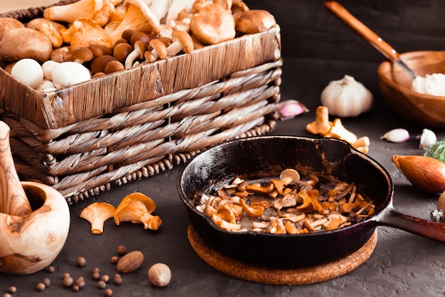 Top view of preparation and frying of edible wild mushrooms