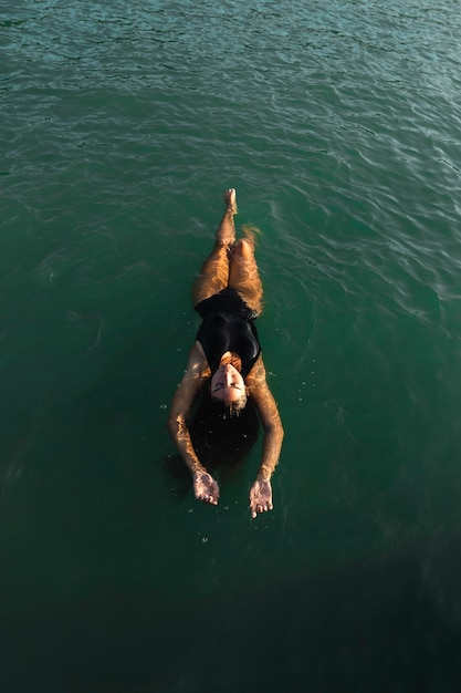 Photo top view pretty young woman enjoying swimming