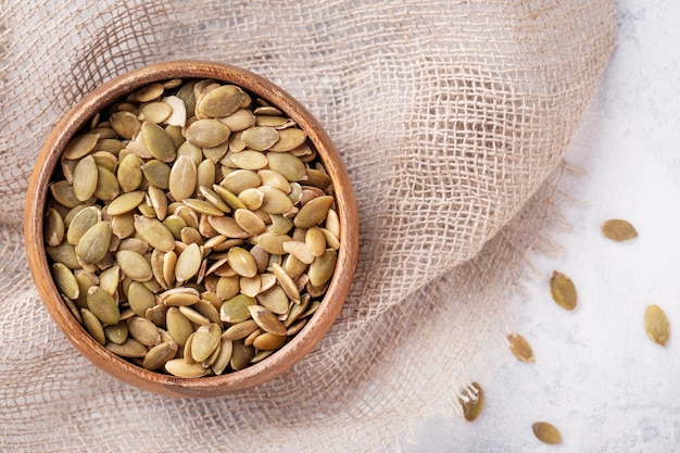 Top view of pumpkin seeds in a bowl. Copy space