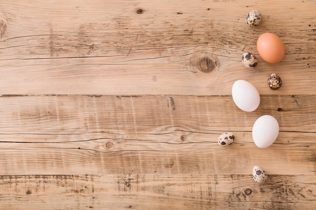 Top view on quail eggs on a wooden background Easter festive background Flat lay