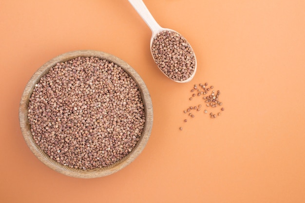 Top view of raw buckwheat in the bowl and spoon