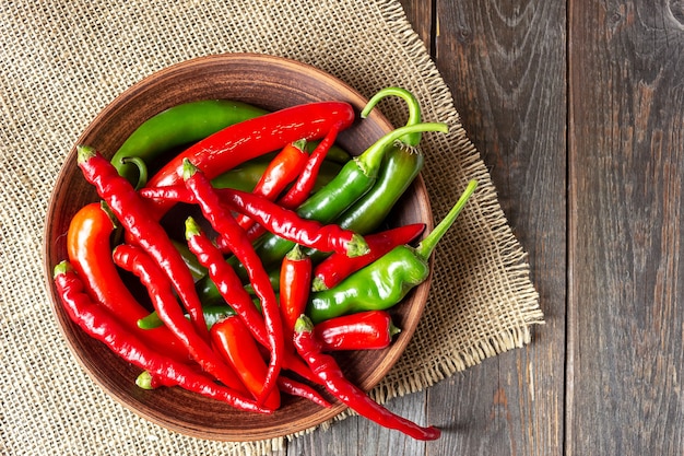 Top view of red chili peppers on a rustic wooden table.