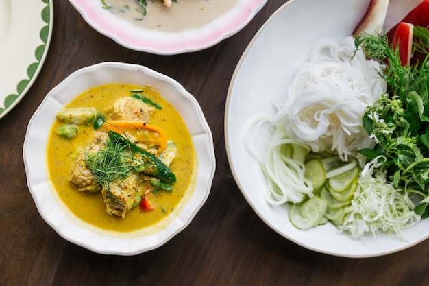 Top view of Rice Noodles with Crab Meat Curry Sauce, Served with vegetables. Classic Thai cuisine.