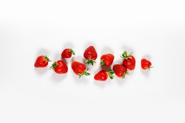 Top view of ripe juicy strawberry berries on a gray background, minimal style