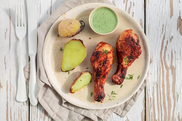 Top view of roasted chicken on rustic white table