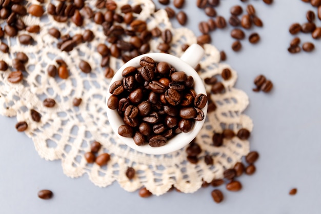 Top view of roasted coffee beans in a mug