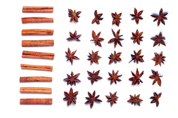 Top view row of aromatic cinnamon sticks and star anise.