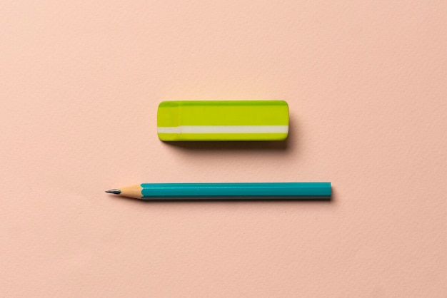 A top view of the rubber eraser with pencil on pastel background