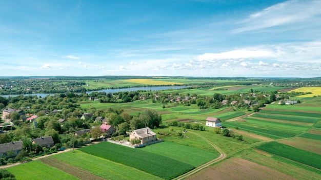 Top view of rural landscape on sunny spring day. House and green field. Drone photography