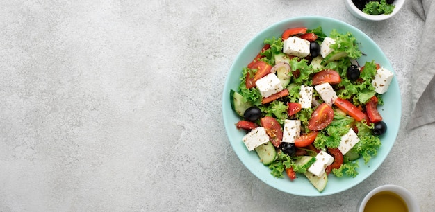 Top view salad with feta cheese, tomatoes and olives with copy-space