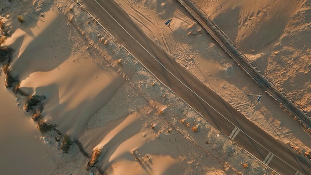 Top view sand road over summer dunes nature aerial asphalt highway stretching