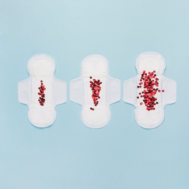 Top view sanitary towel line with red sequins