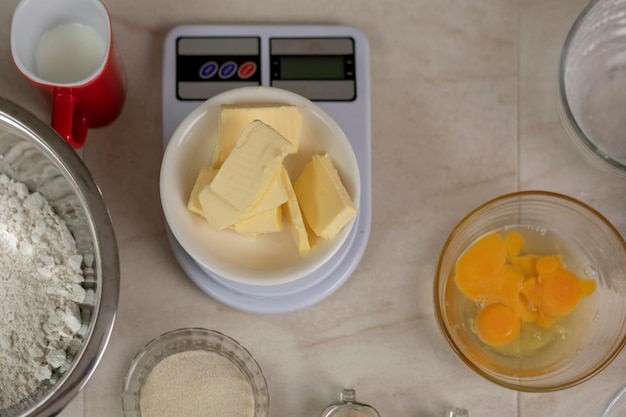 Top view of a scale with butter and other ingredients to prepare bread