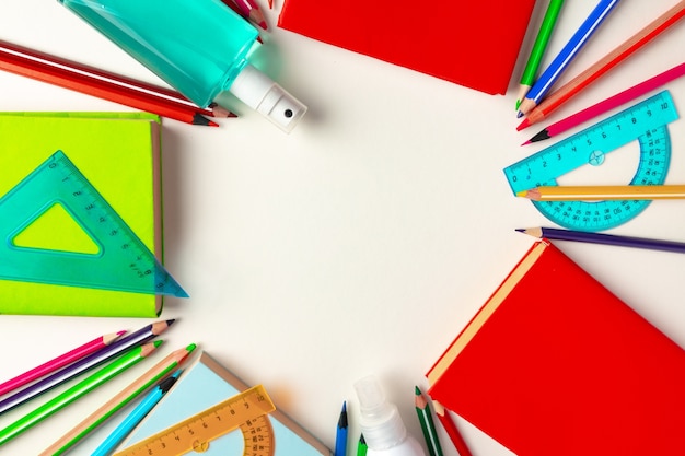 Top view of school supplies, pencils and notepad, copy space