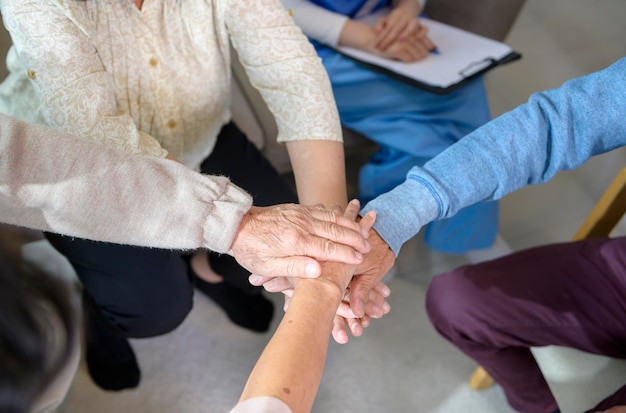 Top view of Seniors people holding hands together in elder health care center concept of old people health care group therapy