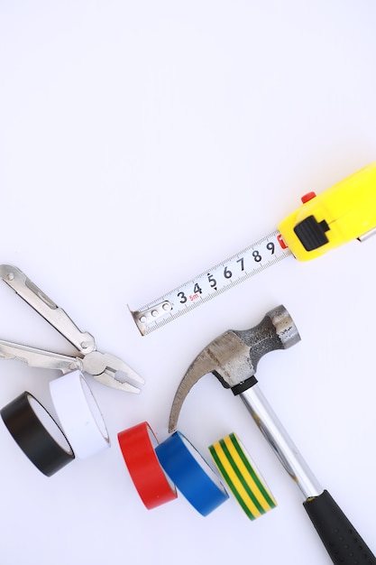 Top view of Set of construction and maintenance tooling for handyman on white concrete background with copy space