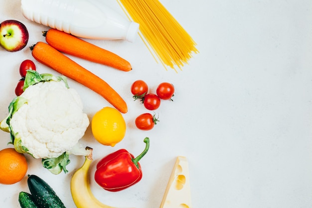 Top view set of food vegetables fruits and dairy products on white background with free space