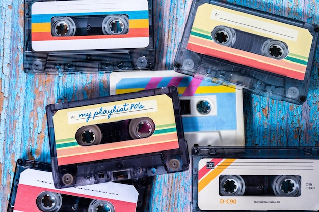 Top view of several music cassettes stacked on wood with pickled paint