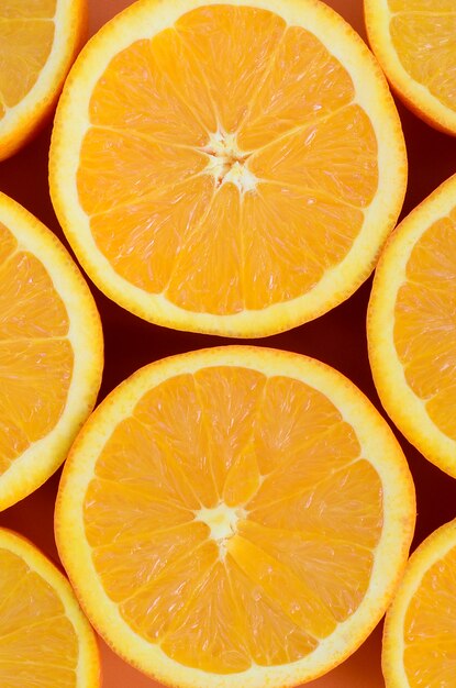 Top view of a several orange fruit slices on bright background 